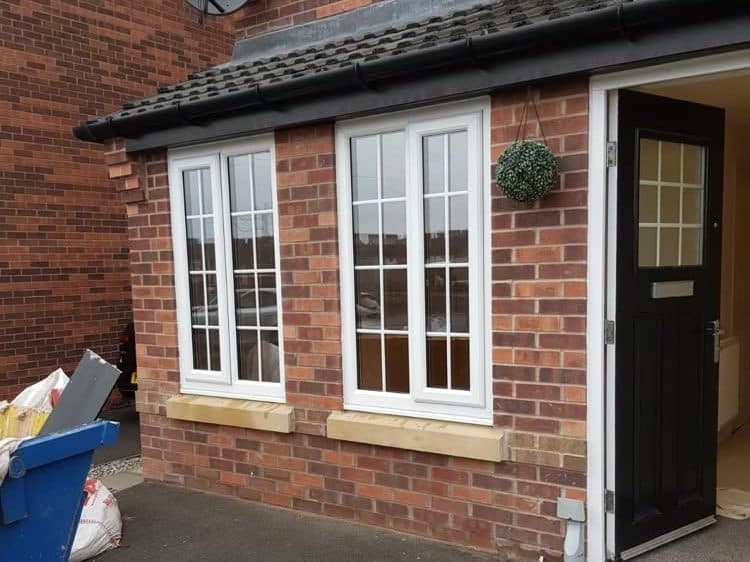 Single-storey brick extension with white French windows and a black front door, built by CS Construction