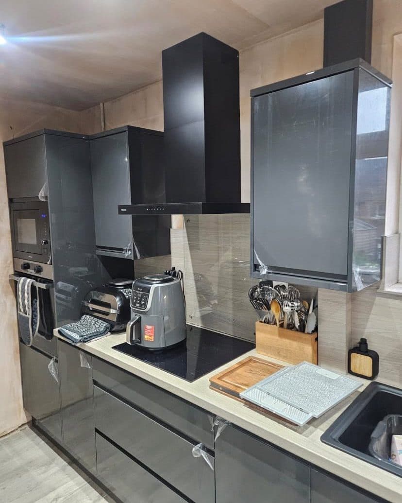 Grey gloss kitchen with a black chimney extractor hood